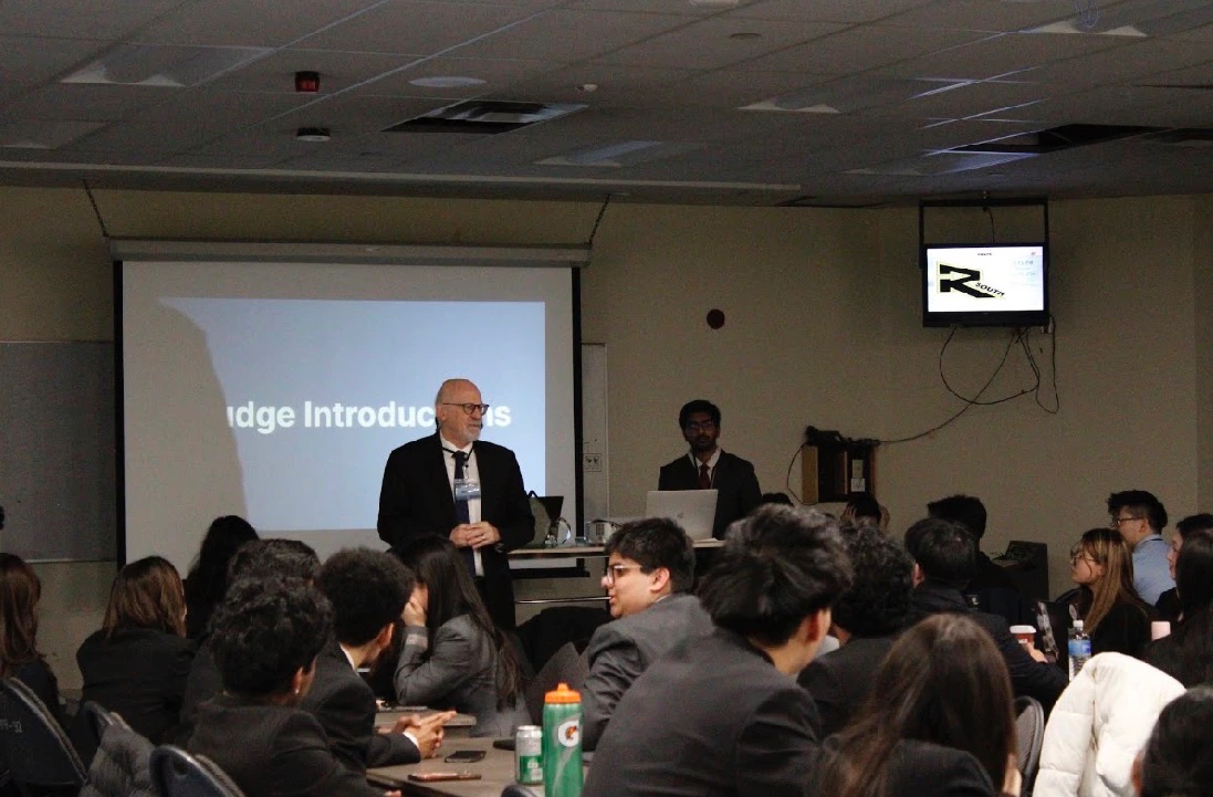 A judge speaking with students at INSPIRE