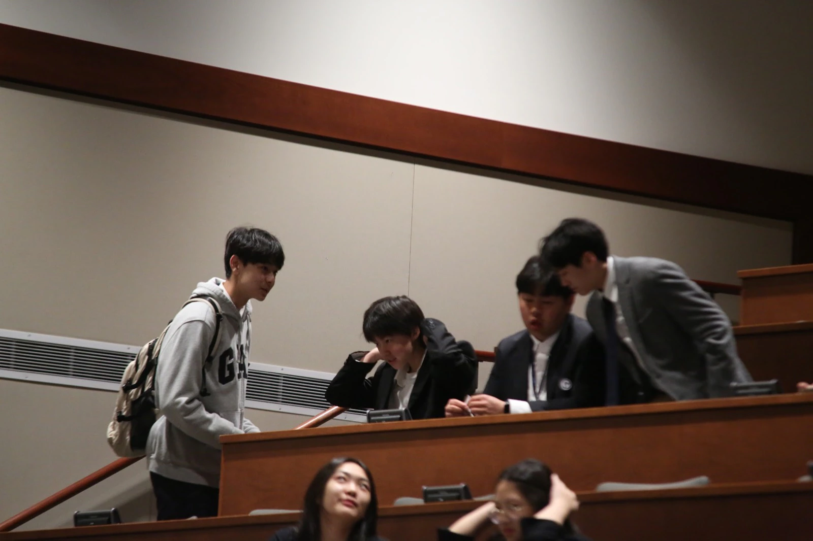 Students exchanging ideas in a lecture hall at Momentum